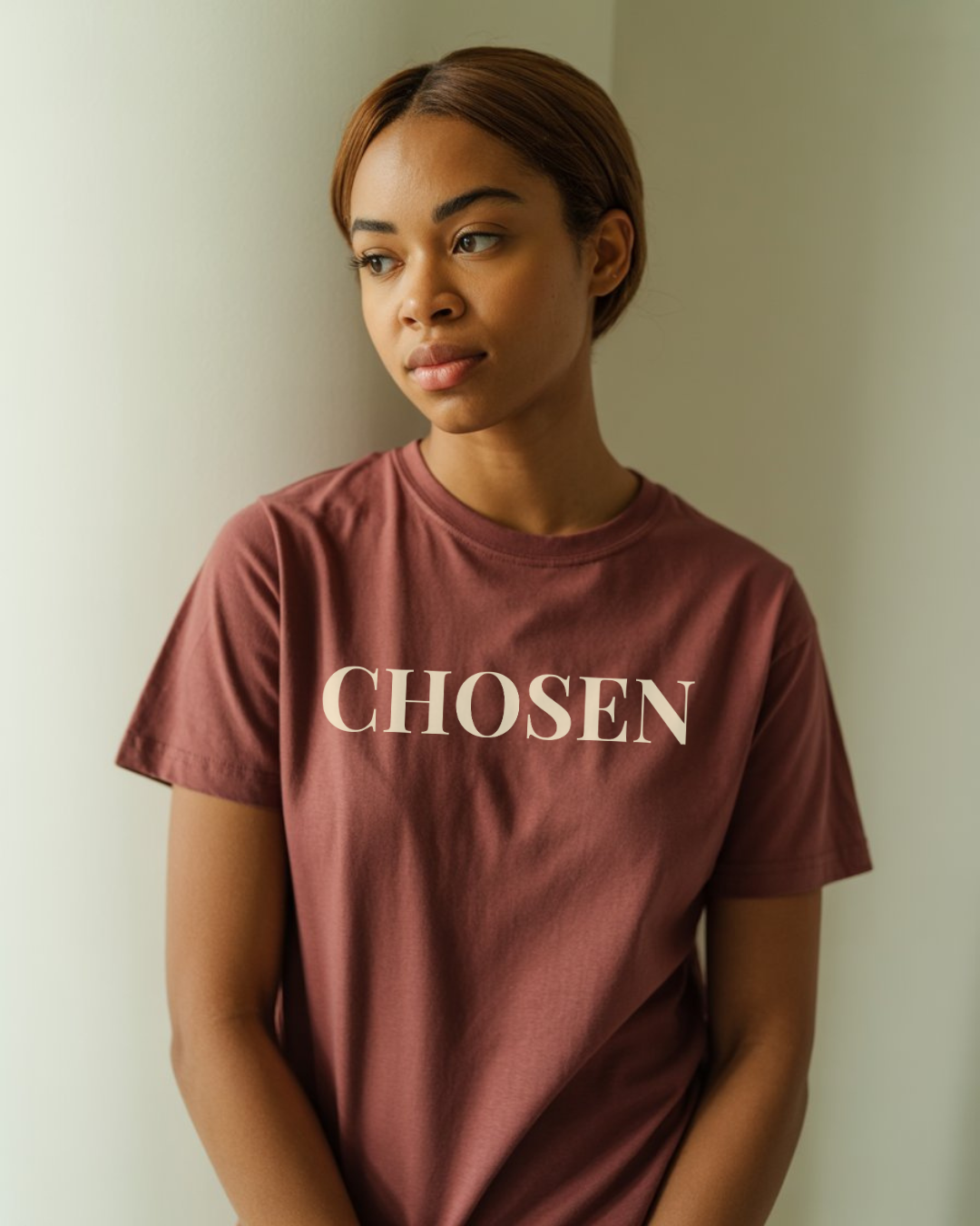 girl wearing a maroon colored christian t-shirt that says chosen